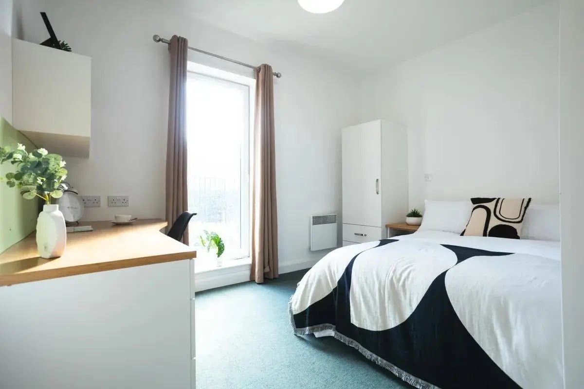Desk vase and bed in student room Bedroom at Riverside House - Manchester in Salford Student Accommodation