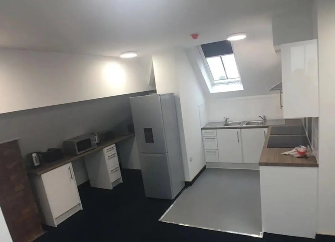 Silver fridge microwave white cabinets kitchen. at Salisbury Road in Leicester Student Accommodation