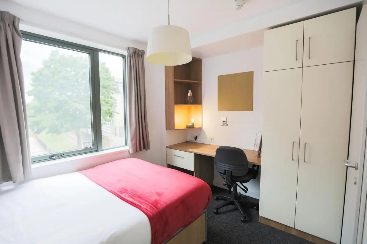 Bed desk wardrobe chair window bedroom at AXO Camden in London Student Accommodation