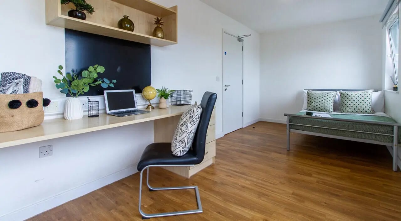 Desk with laptop bed and storage bedroom at Canalside in Birmingham Student Accommodation