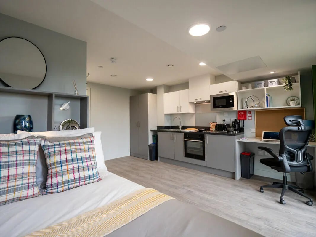 Bed kitchen desk and chair studio apartment at Venue Studios in London Student Accommodation