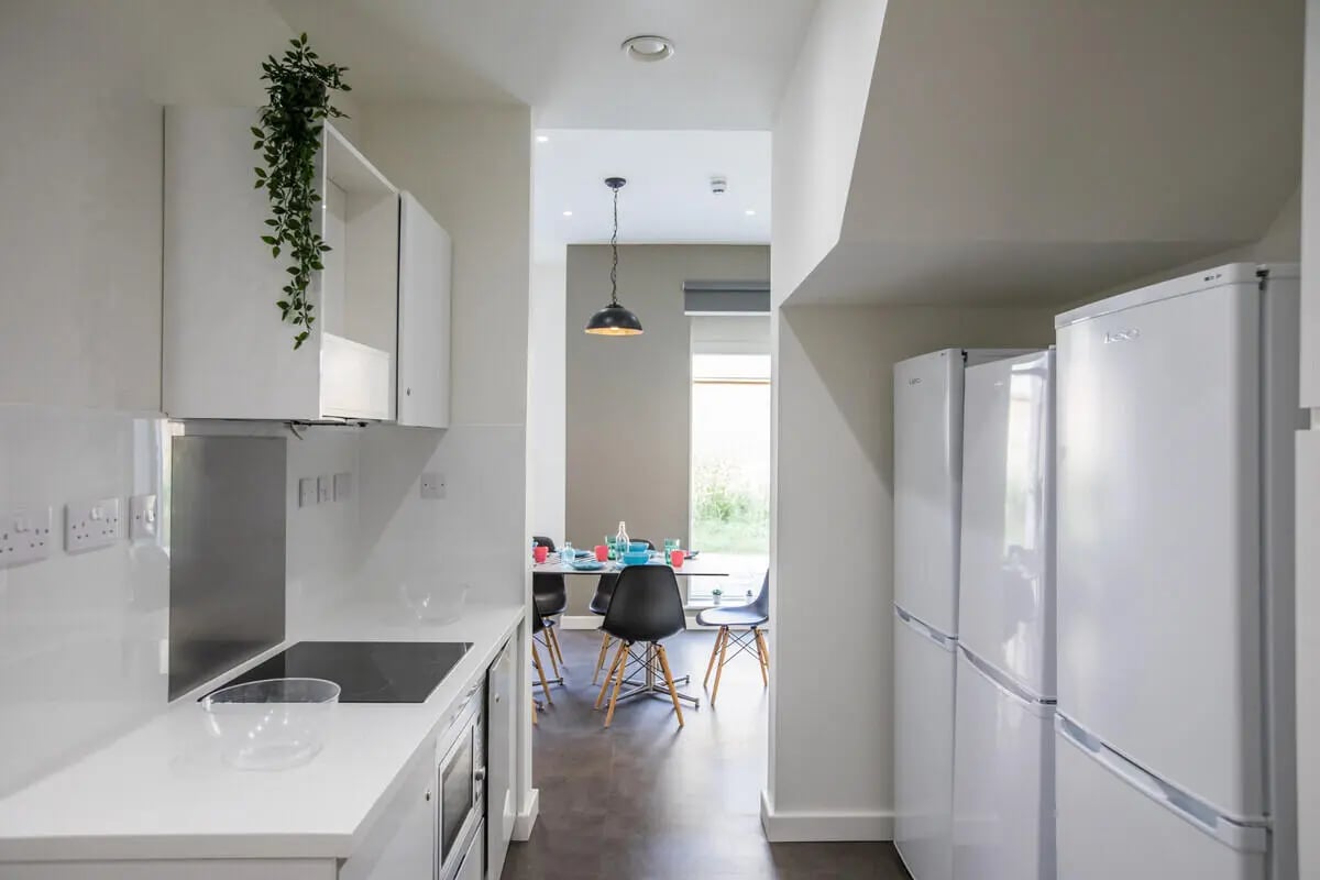 White refrigerators and a kitchen counter kitchen at The Cam Foundry in Cambridge Student Accommodation