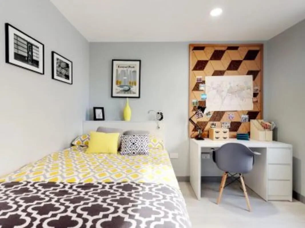Bed with yellow grey pattern desk with chair bedroom at The Walls in Southampton Student Accommodation