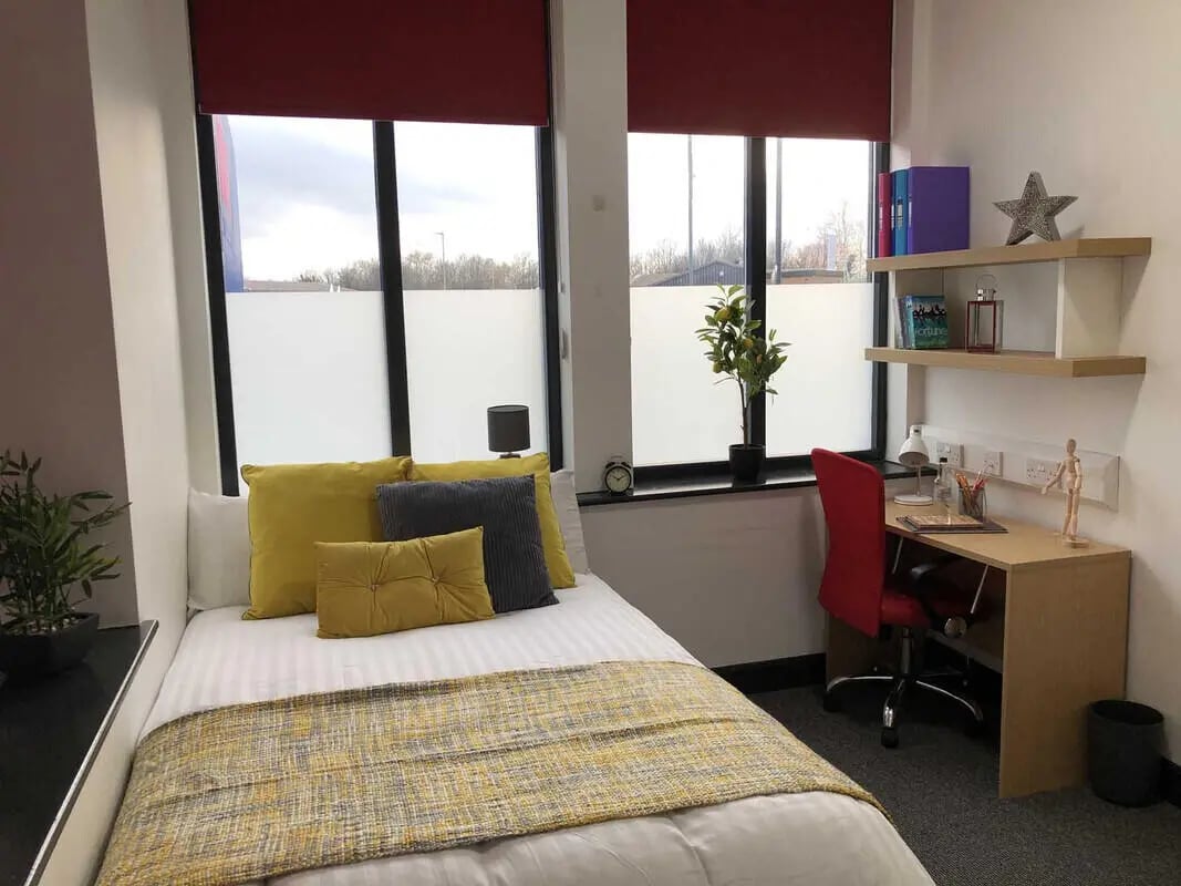 Bed desk chair plant and shelves Bedroom at Mandale Terrace in Stockton-On-Tees Student Accommodation