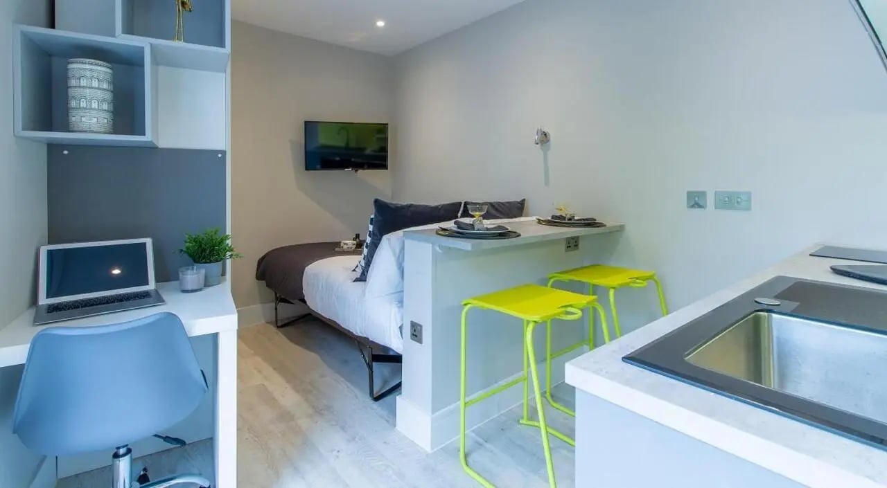 Bed desk kitchen counter with stools studio apartment at AXO Seven Sisters in London Student Accommodation