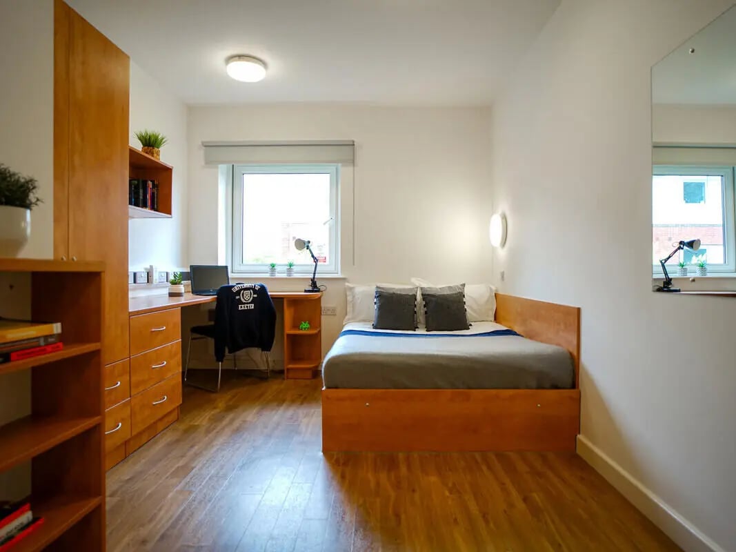 Bed desk wardrobe mirror bedroom at Exeter One in Exeter Student Accommodation