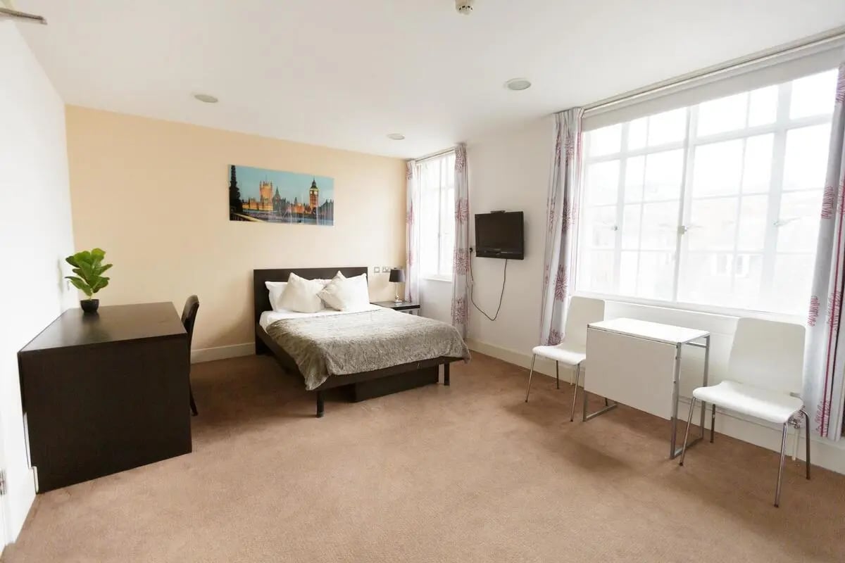 Bed desk TV table chairs bedroom at AXO Oxford Circus in London Student Accommodation