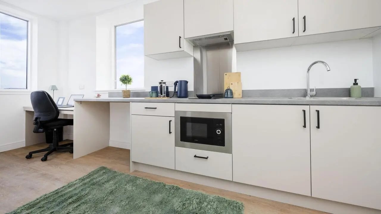 Desk microwave kettle cabinets and sink kitchen at Discovery Studios in Dundee Student Accommodation