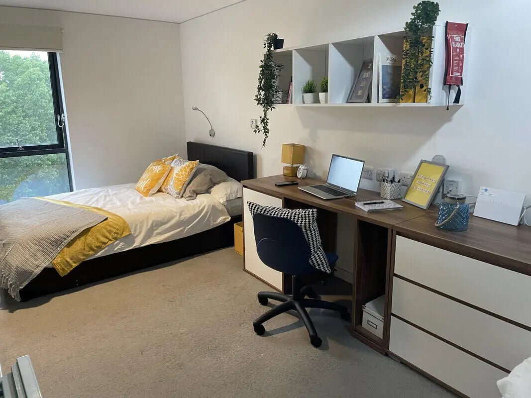 Bed desk chair shelves fire blanket bedroom at Asquith House in Leeds Student Accommodation
