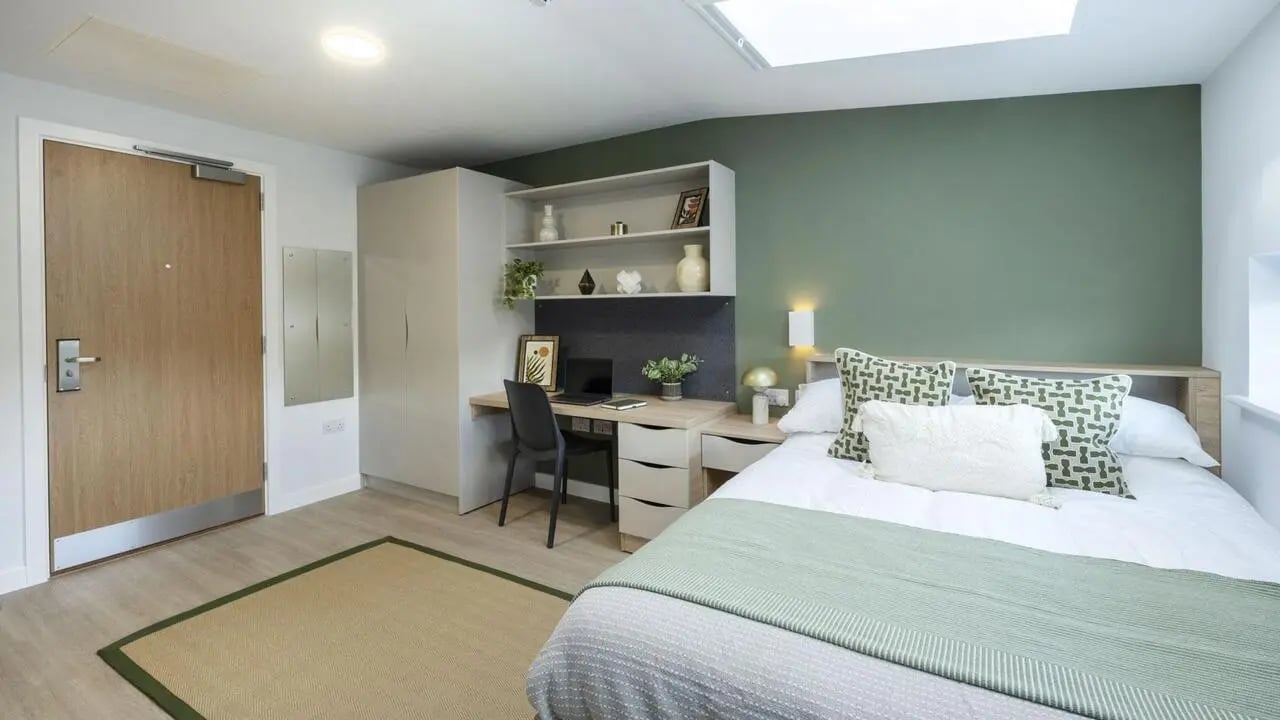 Bed desk wardrobe mirror bedroom interior at Waterloo House in York Student Accommodation