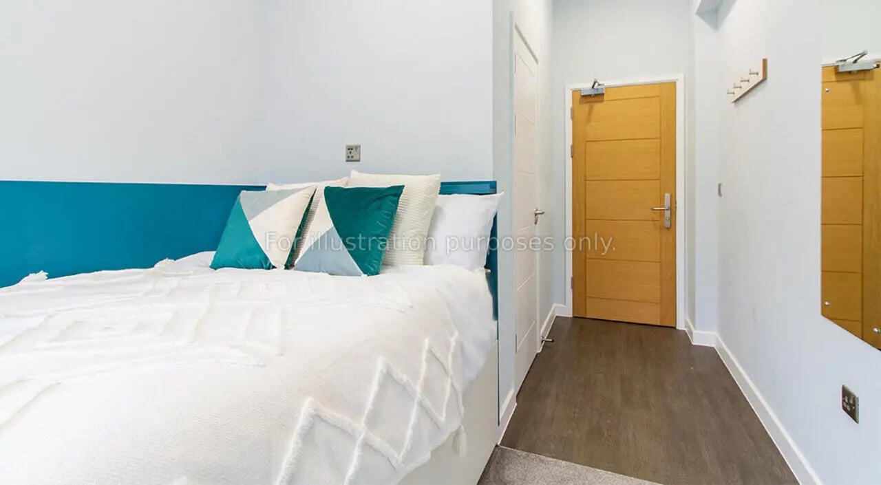 Bed with pillows and blue headboard bedroom at Urban Student Village in Coventry Student Accommodation