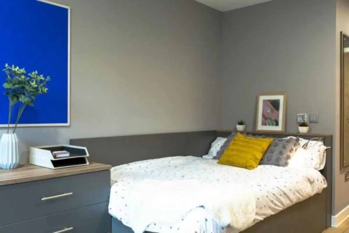 Bed with patterned duvet and yellow pillow bedroom at Luneside in Lancaster Student Accommodation