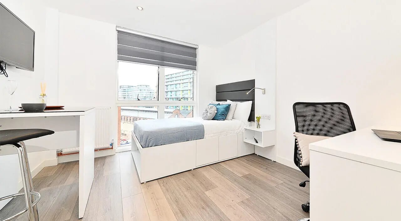 Bed desk chair and window bedroom at Miura in Nottingham Student Accommodation