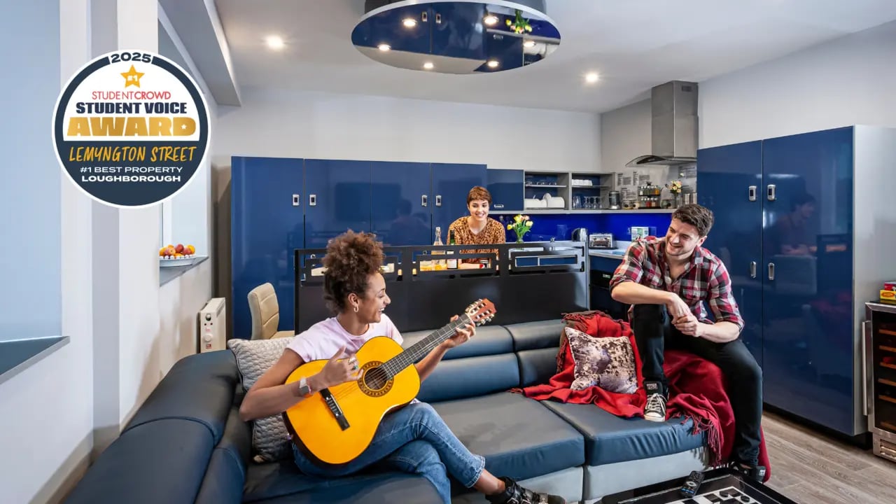 Students playing guitar and relaxing in living area at Study Inn Loughborough - Lemyngton Street in Loughborough Student Accommodation