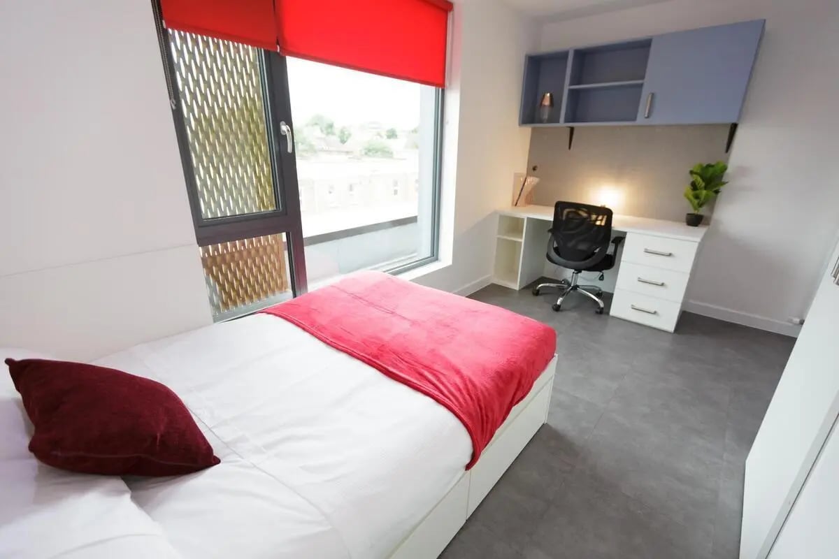 Bed desk chair and plant Bedroom at AXO New Cross in London Student Accommodation