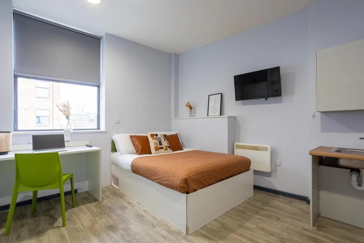 Bed study desk laptop green chair bedroom at dwell Archer House in Nottingham Student Accommodation