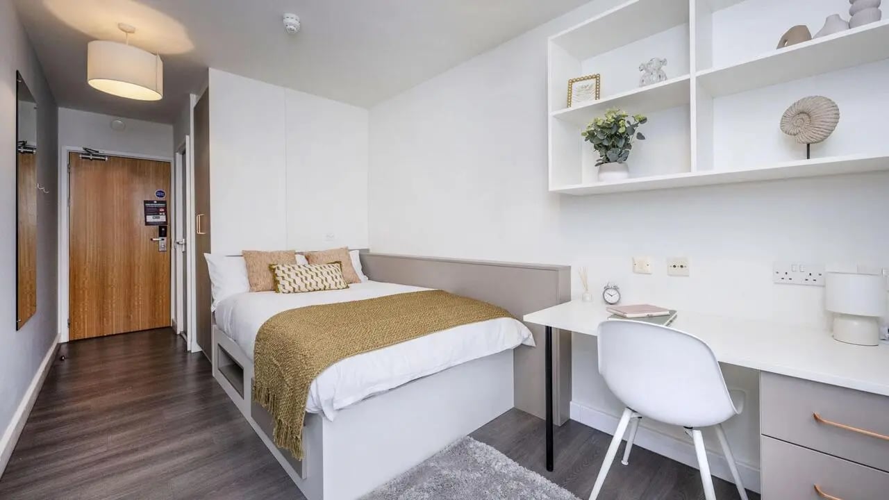 Bed desk shelves and door Bedroom at Charles Morton Court in London Student Accommodation