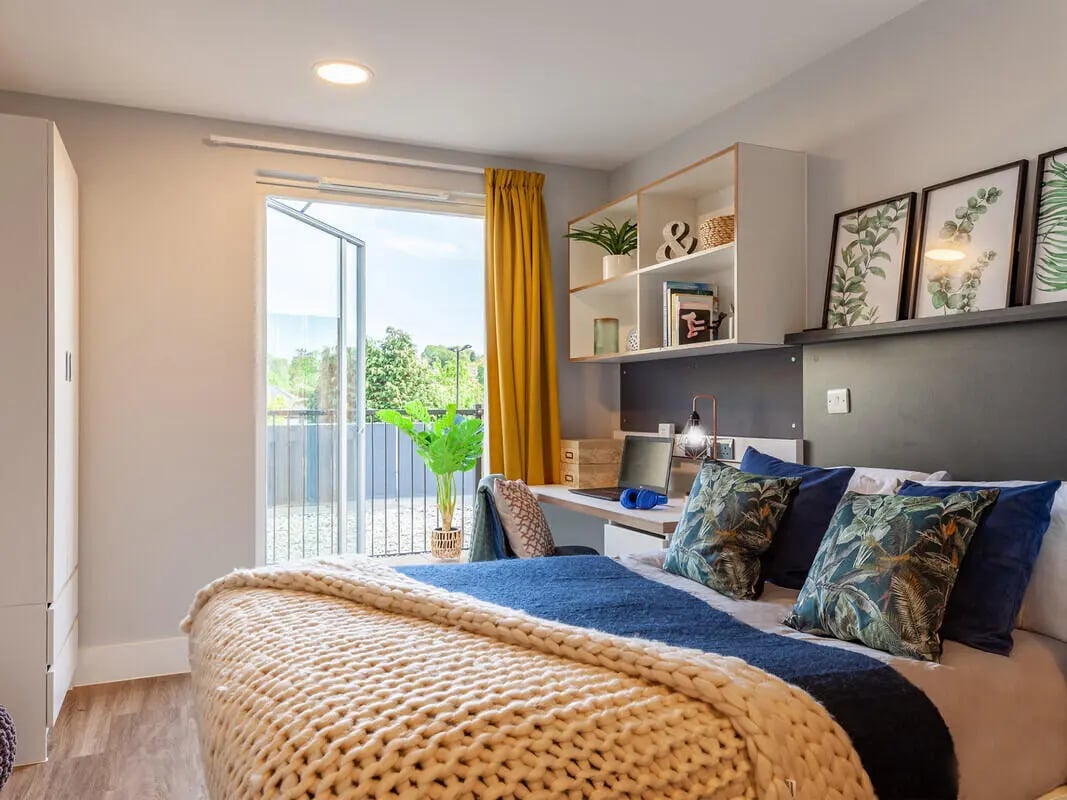 Bed study area with open balcony bedroom at West Way Square in Oxford Student Accommodation