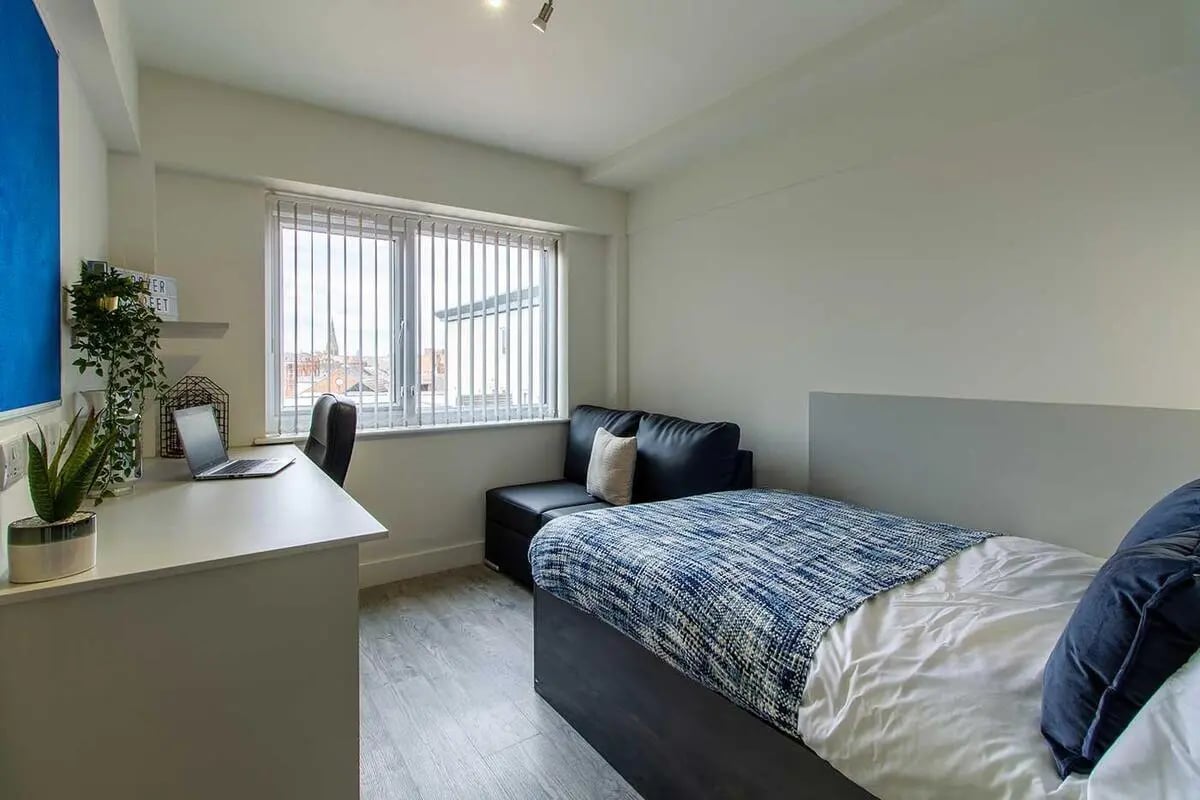 Desk laptop couch bed and window Bedroom at Dover Street Apartments in Leicester Student Accommodation