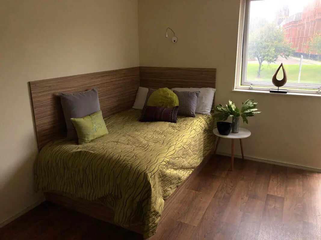 Bed with patterned quilt pillows and bedside table bedroom at Falkland House in Liverpool Student Accommodation