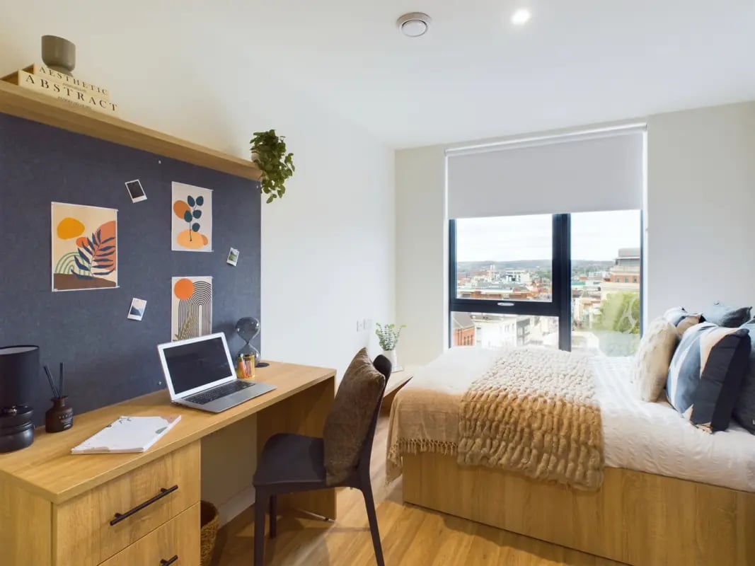 Desk laptop art and bed bedroom at Straits Aire in Leeds Student Accommodation