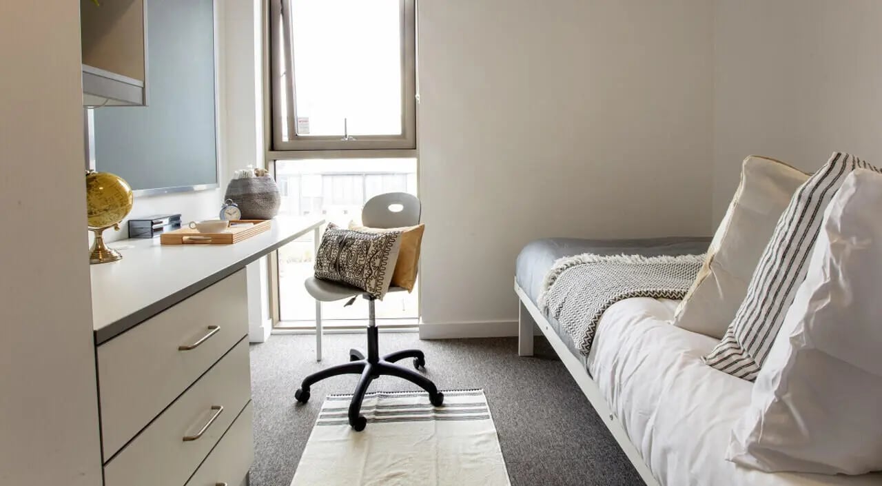Desk globe chair and bed bedroom at East Shore in St Andrews Student Accommodation