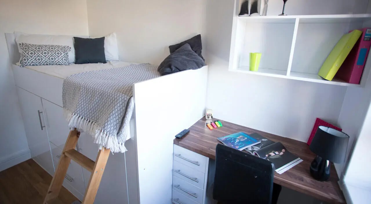 Loft bed with ladder desk and shelf Bedroom at Surrey Quays Landale House in London Student Accommodation