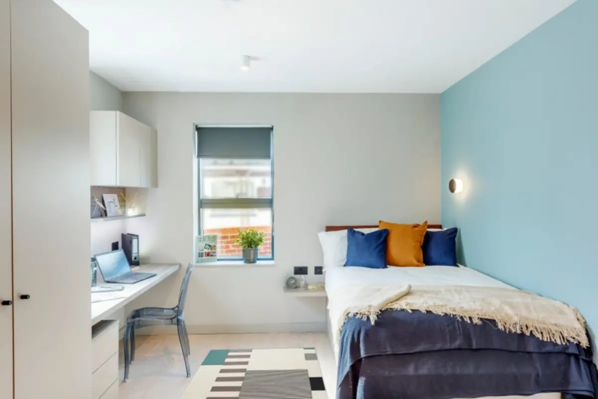 Desk bed window and storage bedroom at The Garage Egham in Egham Student Accommodation