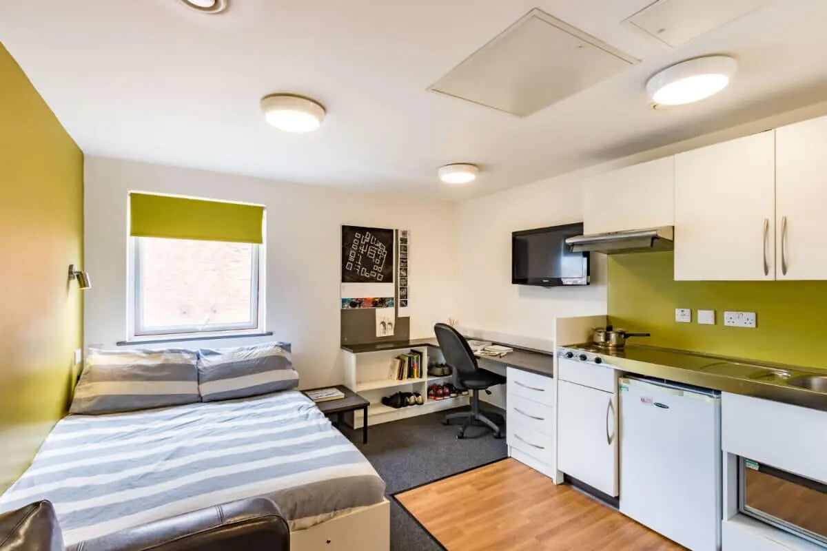 Bed desk kitchen area with television and cabinets study room at Russell View in Nottingham Student Accommodation