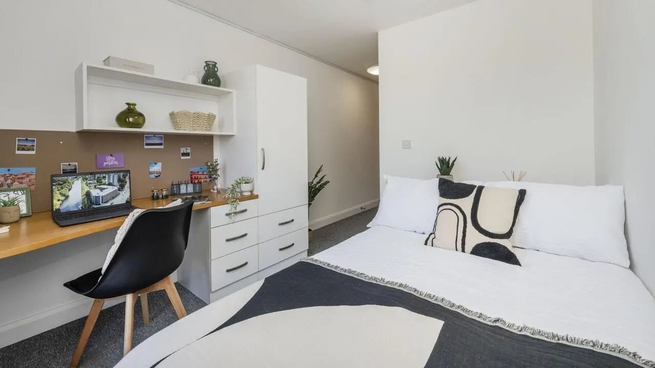 Desk bed wardrobe and shelving bedroom at Riverside House - Manchester in Salford Student Accommodation