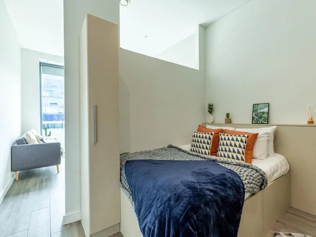 Bed with blue blanket patterned pillows bedroom at Redvers Tower in Sheffield Student Accommodation