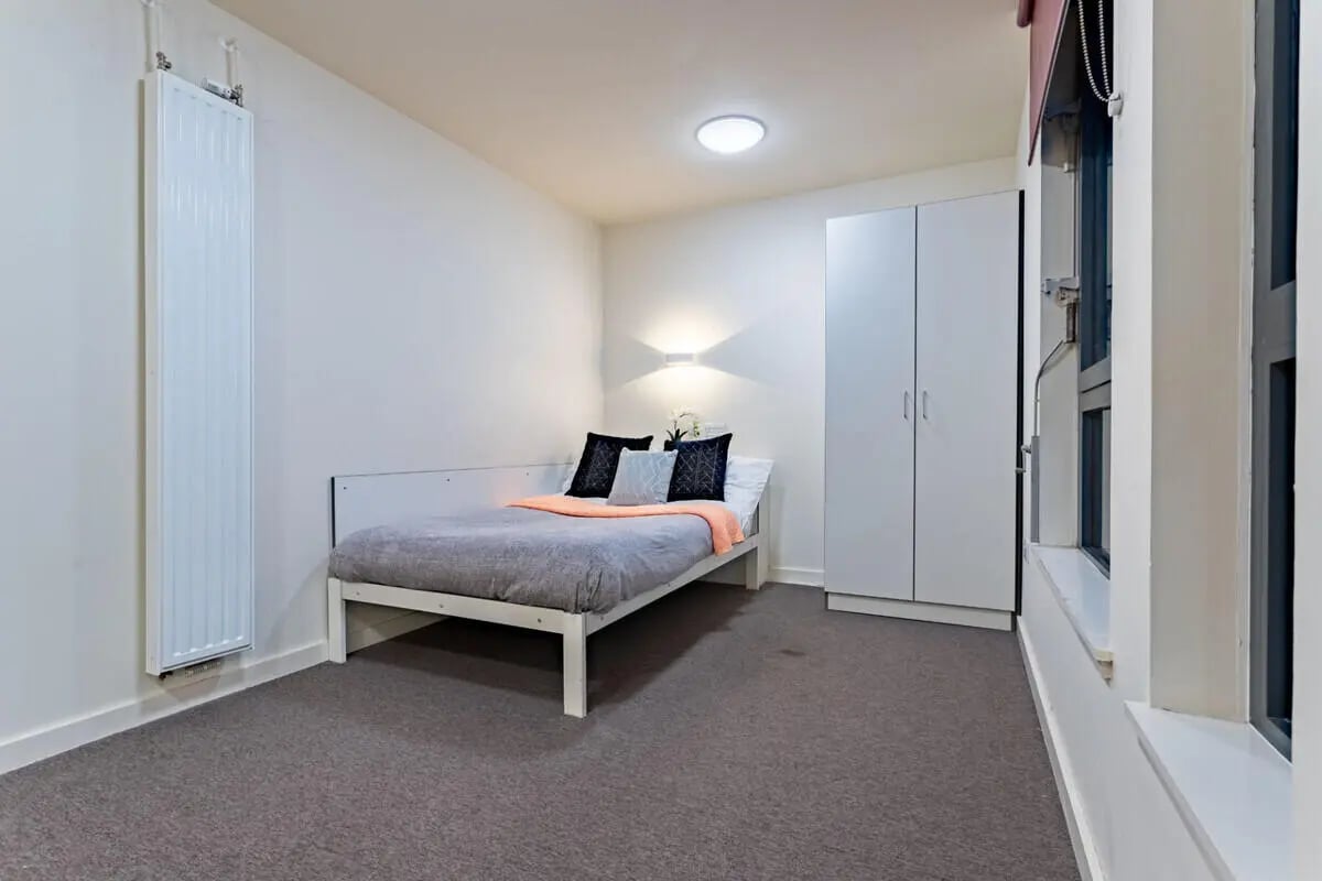 Bed wardrobe radiator and window bedroom at Powis Place in Aberdeen Student Accommodation