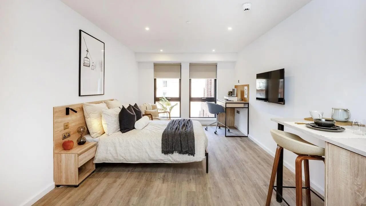 Bed desk chair television kitchen area studio apartment at The Fabric Works in Leeds Student Accommodation