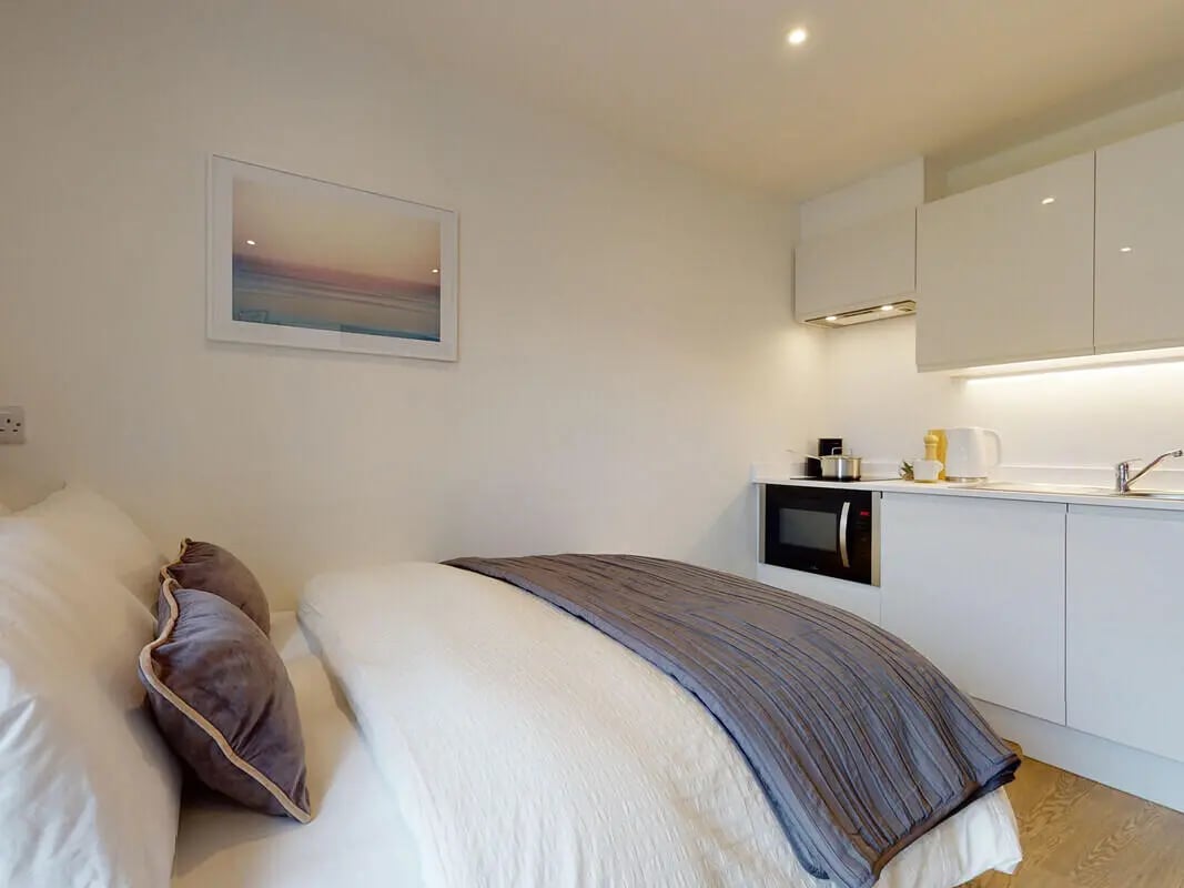 Bed pillows framed picture microwave kitchen Living area at One London Road in Newcastle Under Lyme Student Accommodation