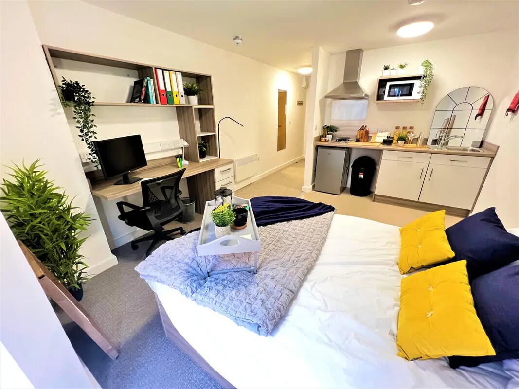 Bed desk kitchen area studio apartment at Q Studios in Stoke-On-Trent Student Accommodation