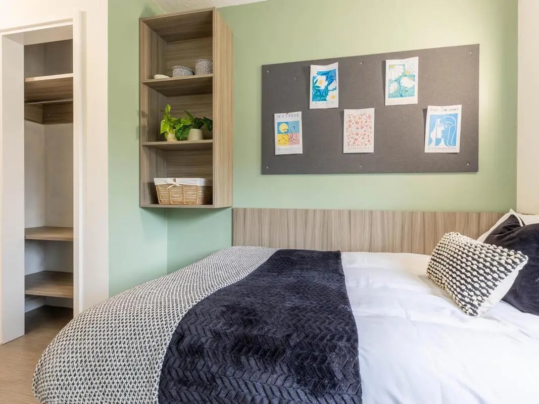 Bed with bedside shelf and closet Bedroom at Hamwic Hall in Southampton Student Accommodation