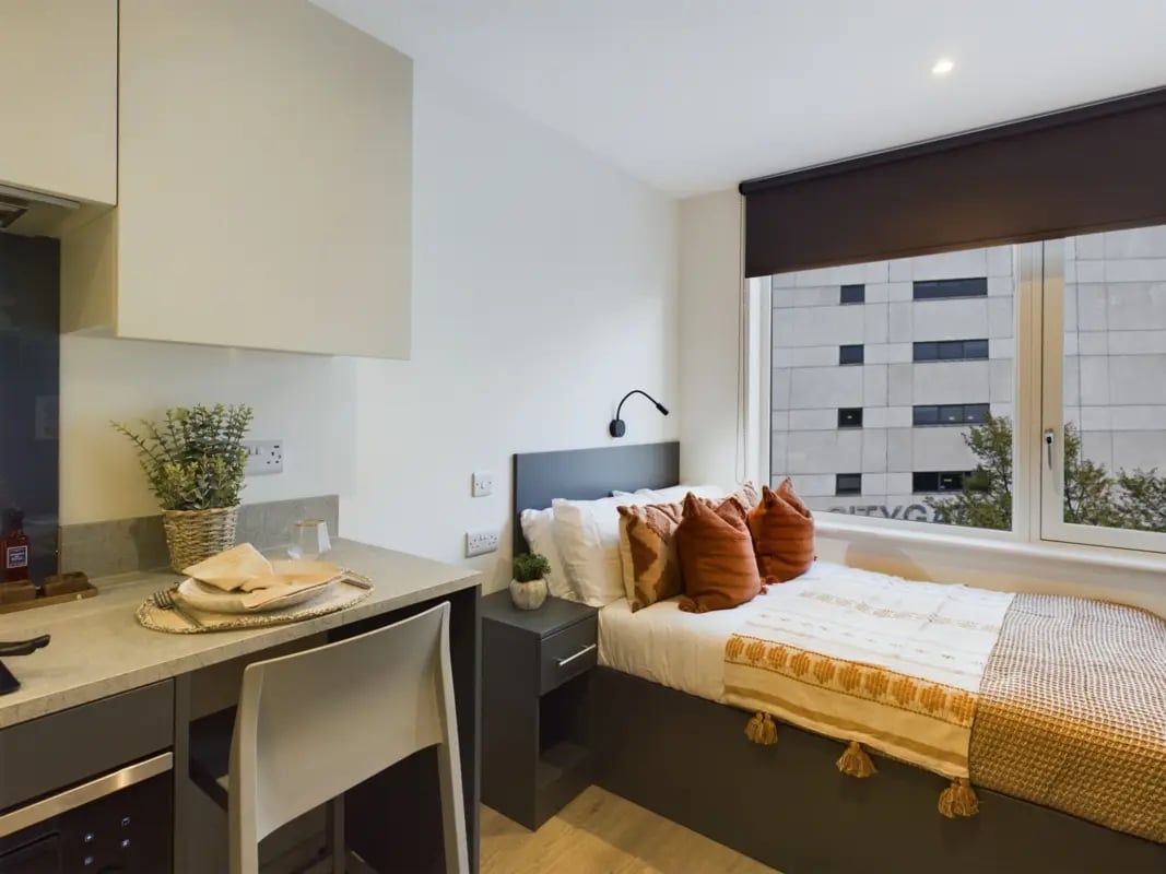 Bed kitchen area with desk and chair bedroom at Sheares Hall in Newcastle Upon Tyne Student Accommodation