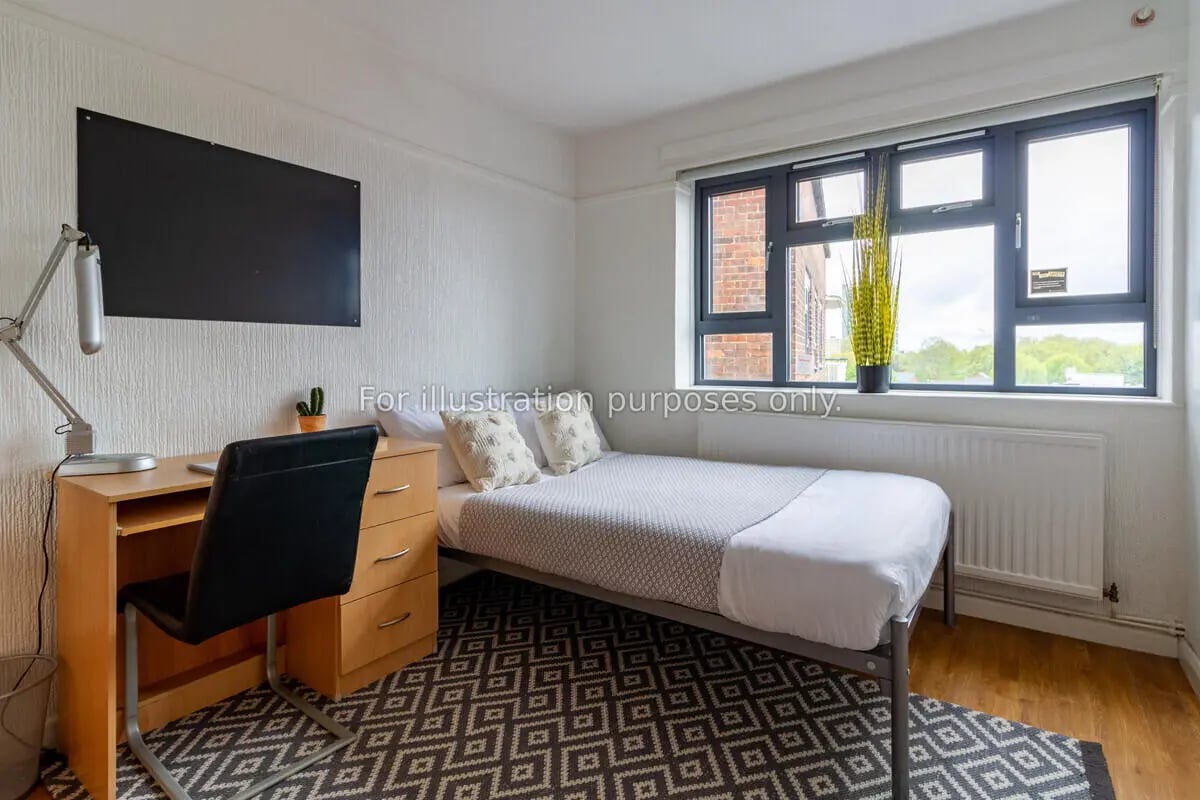Desk bed black chair patterned rug bedroom at Surrey Quays Landale House in London Student Accommodation