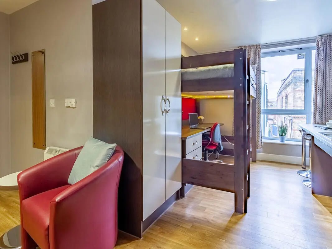 Bunk bed study area red chair wardrobe living room at Camden Hawley Crescent in London Student Accommodation