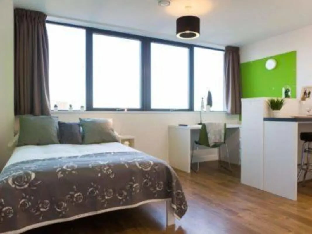 Bed desk chair and plant student studio bedroom at St Lawrence House in Bristol Student Accommodation