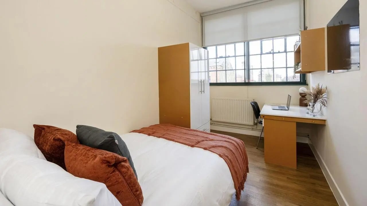 Bed wardrobe desk and laptop bedroom at Nottingham Square in Nottingham Student Accommodation