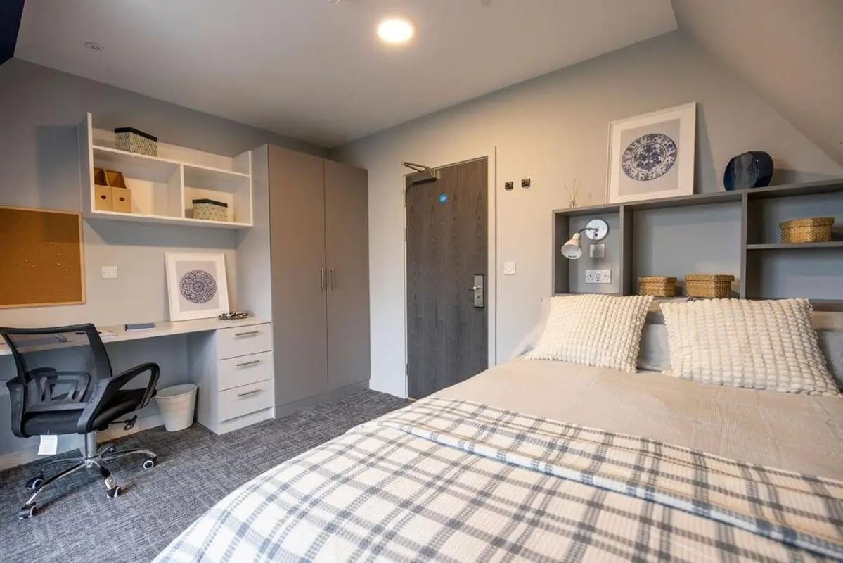 Bed desk wardrobe and door student bedroom at Ash Grove Court - Guildford in Guildford Student Accommodation