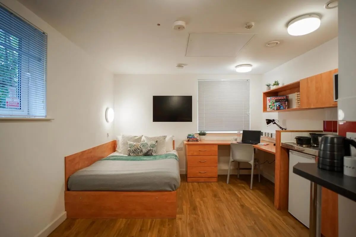 Bed desk laptop TV kitchen area studio apartment at Exeter One in Exeter Student Accommodation