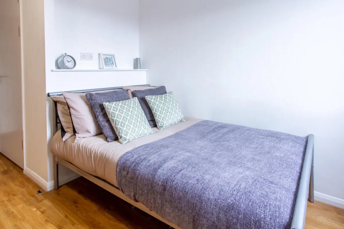 Bed with pillows blankets and shelf bedroom at Danesgate House in Lincoln Student Accommodation