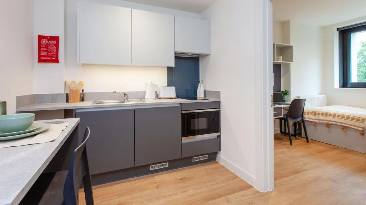 Kitchen, table, microwave, bed, desk bedroom at Sheares Hall in Newcastle Upon Tyne Student Accommodation