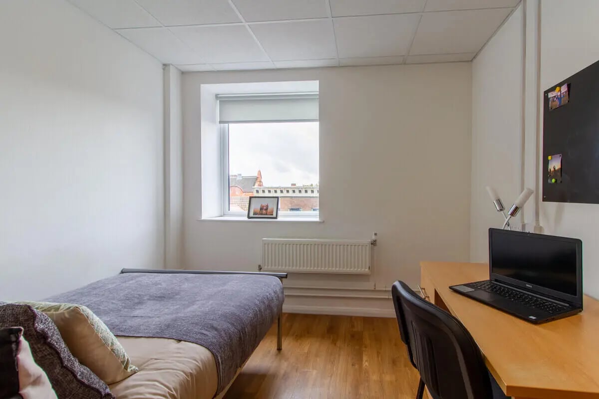 Bed desk laptop and window bedroom at Danesgate House in Lincoln Student Accommodation