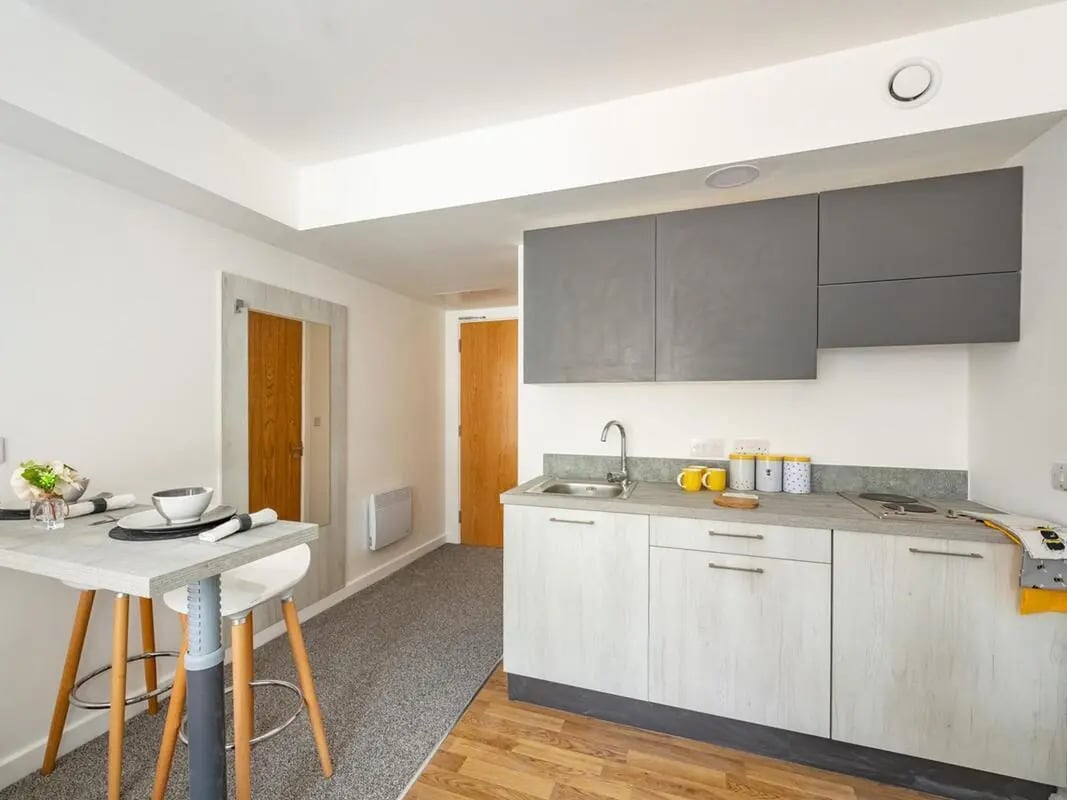 Bar table with stools and kitchen area kitchen at Foundry Studios in Lancaster Student Accommodation