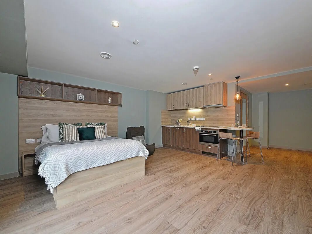 Bed with kitchen and dining area studio apartment at Fontenoy Apartments in Liverpool Student Accommodation