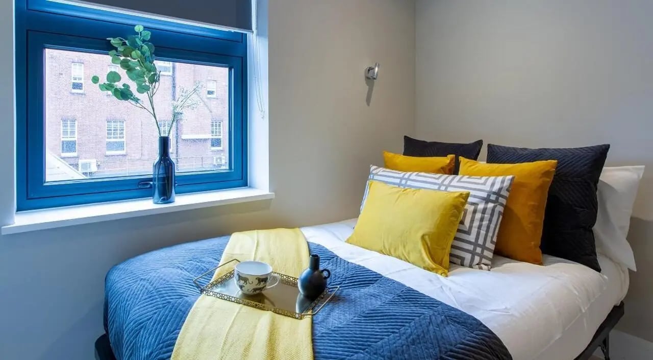 Bed pillows tray vase near window bedroom at AXO Seven Sisters in London Student Accommodation