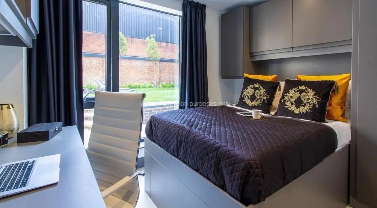 Bed desk chair and laptop bedroom exterior at The Residence in Coventry Student Accommodation